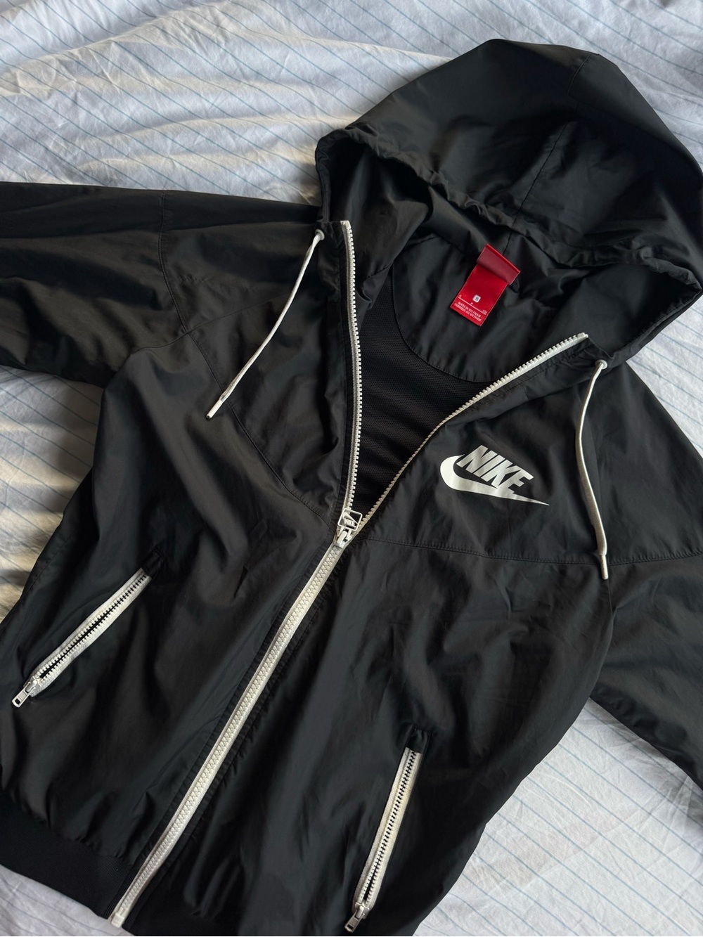 Nike Black Hooded Jacket with White Accents and Red Tag